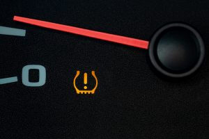 Car low tire pressure warning light. Vehicle repair, maintenance