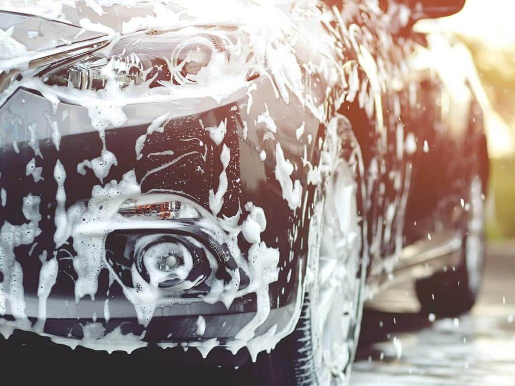 car being washed in sun to protect paint finish