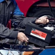 Mechanic replacing dead car battery