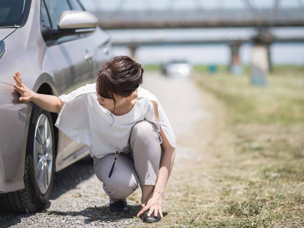 woman inspecting car before buying