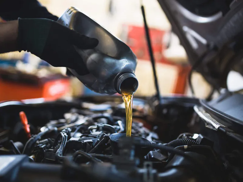 Close up hands of unrecognizable mechanic doing car service and maintenance.