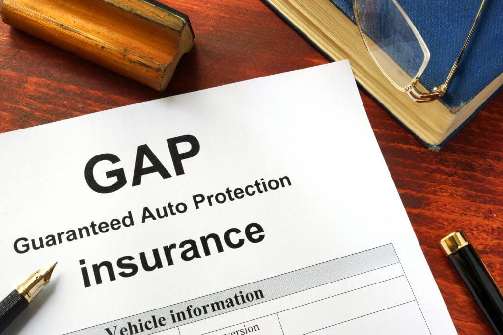 GAP insurance form on a table with a book.