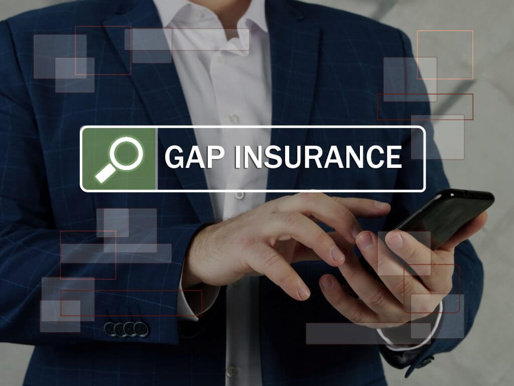 GAP INSURANCE Guaranteed Auto Protection phrase on the screen. Broker use cell technologies at office. Gap insurance is a type of auto insurance that car owners can purchase to protect themselves against losses