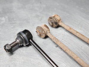 New stabilizer bar or link arm ready to replacement into car suspension on metal table in garage for repair and maintenance. Car part and suspension concept.