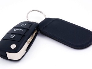 car key with leather fob and remote central locking against a white background