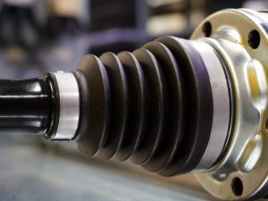 A protective boot mounted on the wheel drive of a modern car.