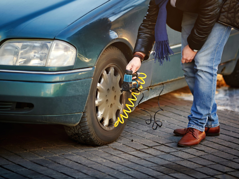 Man checking Tire Pressure