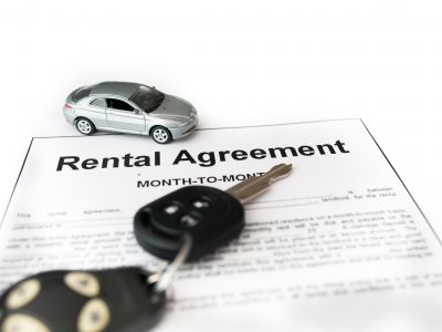 Car rental agreement with car on center. Auto rental agreement or legal document