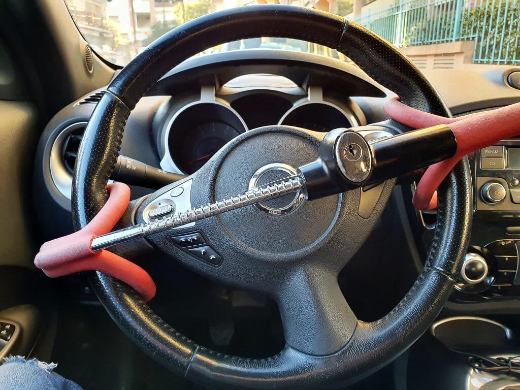 Anti-Theft Car Steering Wheel Lock Car Security. Black And Red Colors. Close Up View