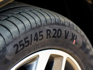 Close up view of tire with tire width, height and wheel diameter designation. Tire size types labels.