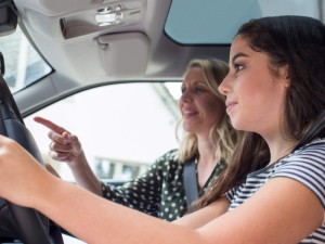 Teenager Having Driving Lesson With Female Instructor
