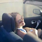 young female driver smiling behind the wheel