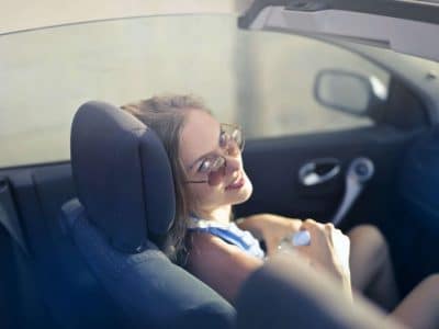 young female driver smiling behind the wheel