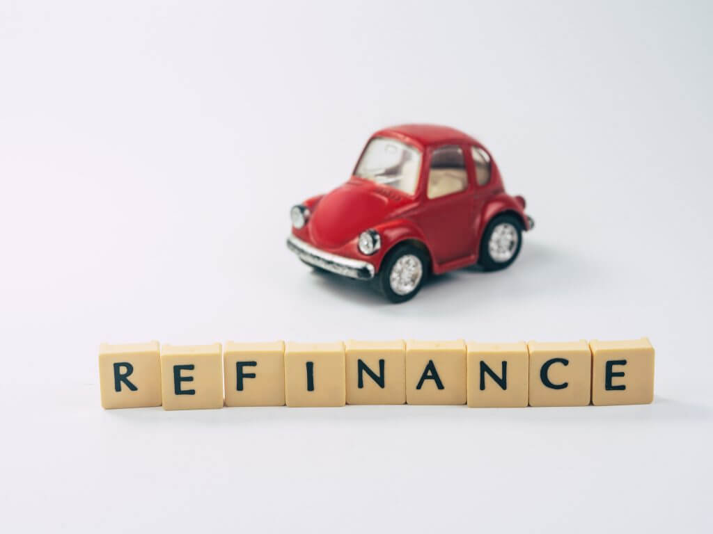 REFINANCE word written in cube with toy car in white background, trade car for cash concept