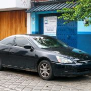 Black coupe Honda Accord in the city street.