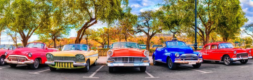 Colorful group of classic cars in Old Havana, a typical attraction of Cuba