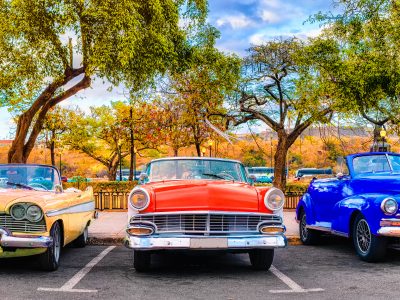 Colorful group of classic cars in Old Havana, a typical attraction of Cuba