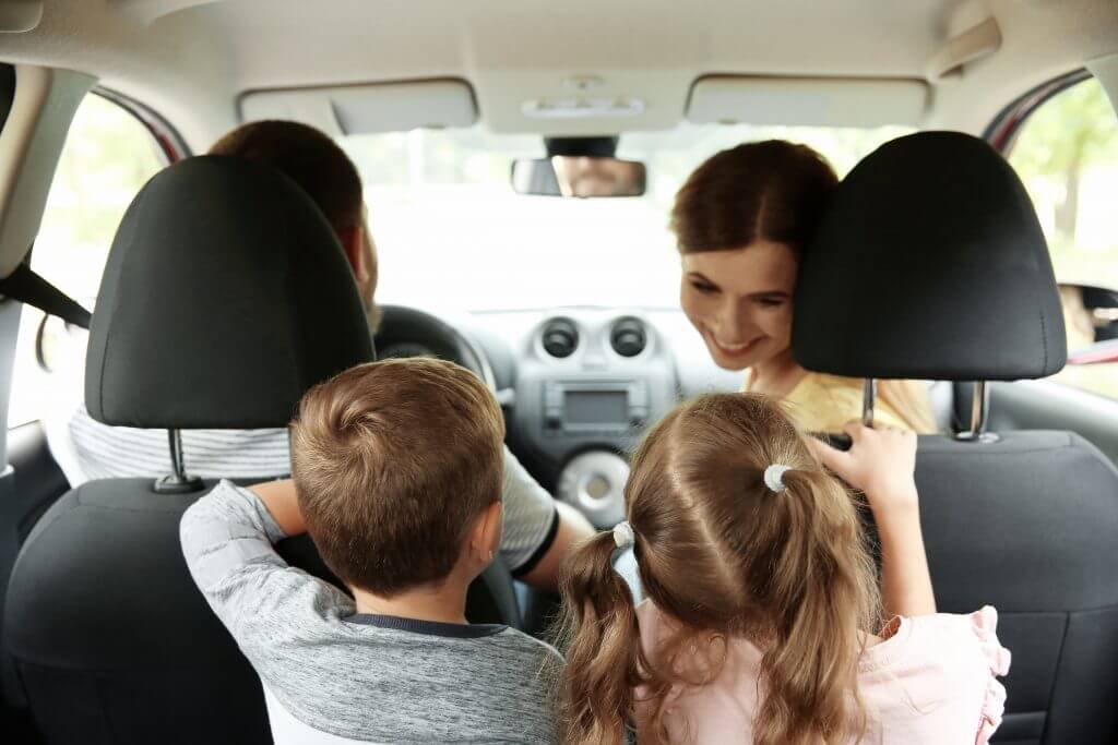 Happy family with children taking road trip together