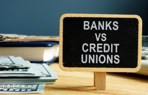 Banks vs Credit Unions concept. Money and ledger.