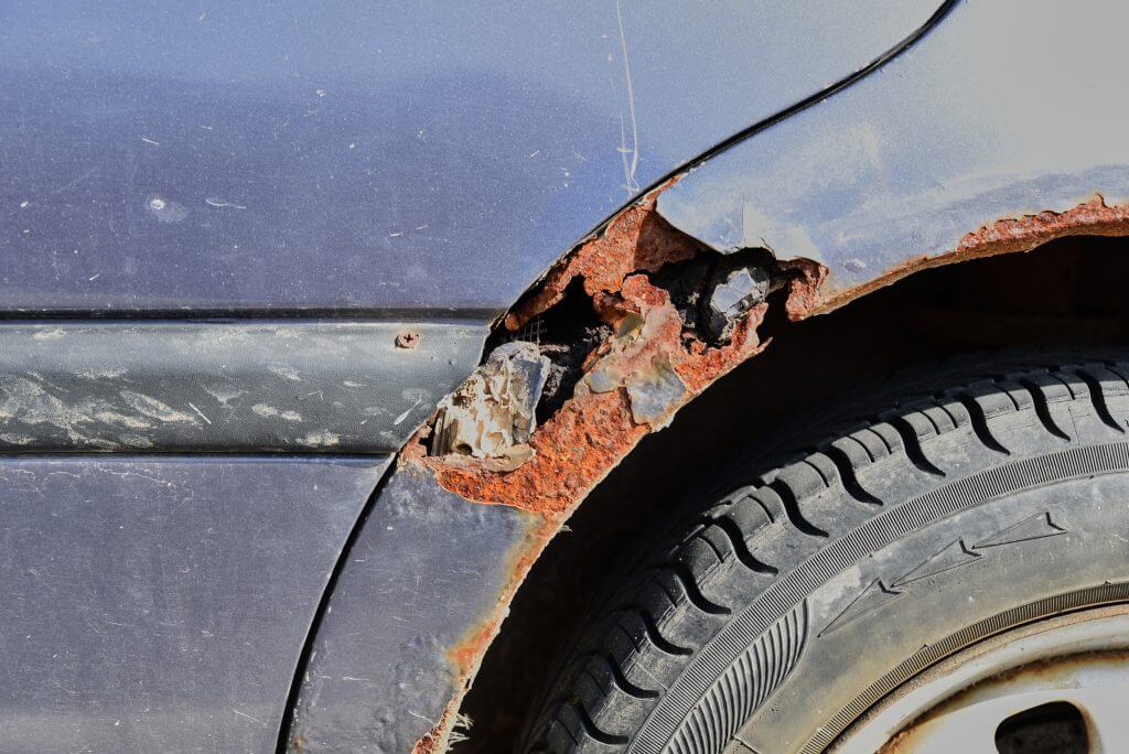Rusty old car damaged by corrosion