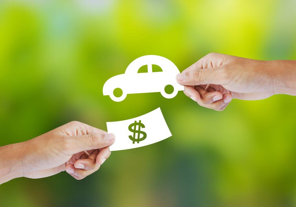 Hand with paper money and car shape. new car buy concept
