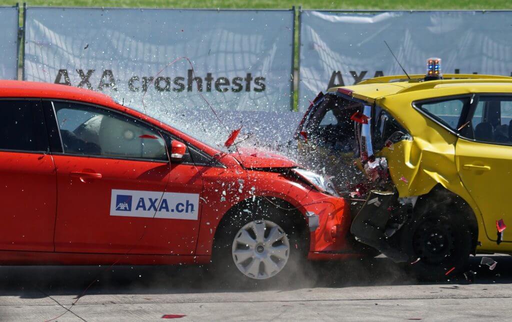 A red car ramming into a yellow car