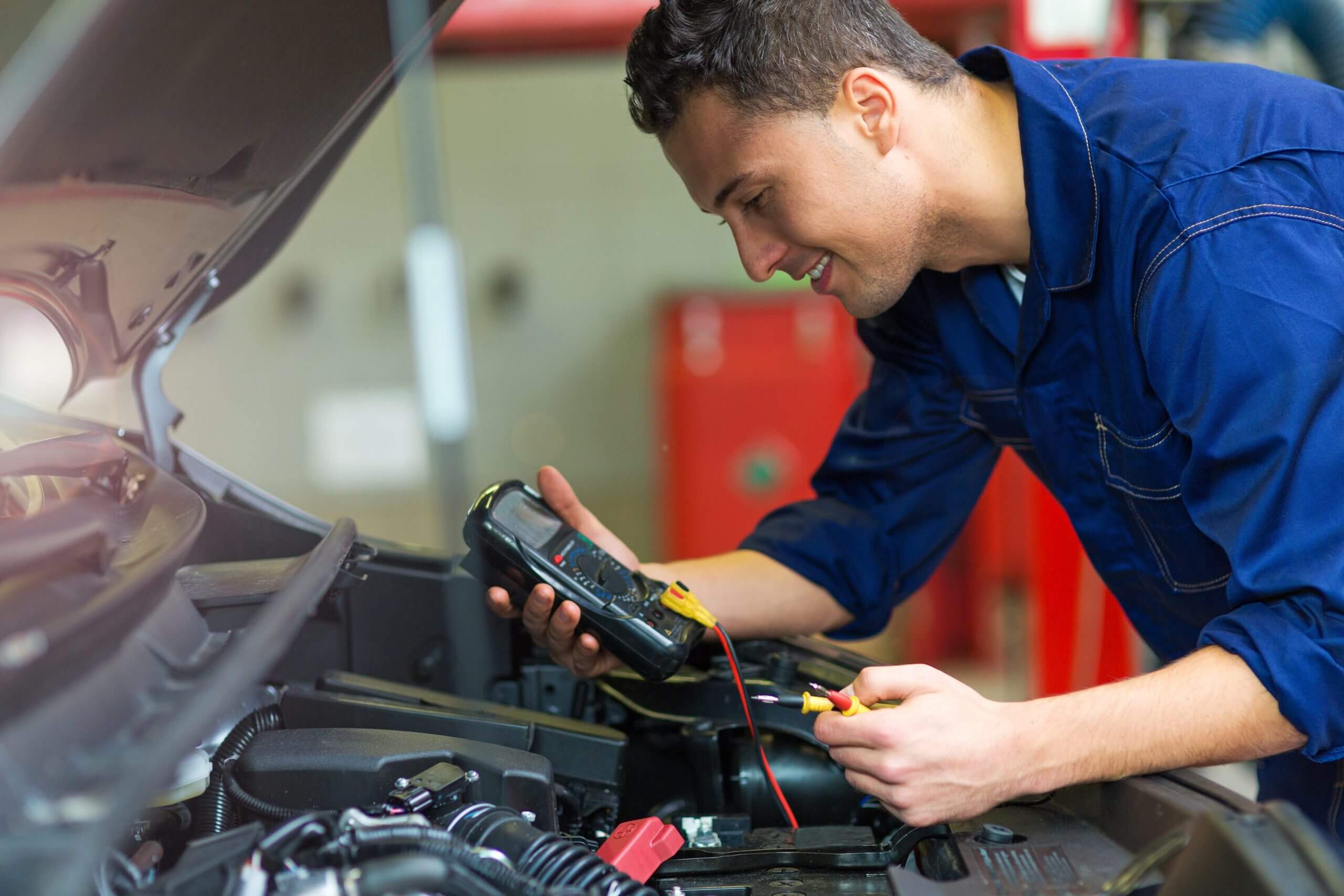 mechanic checking on a car battery