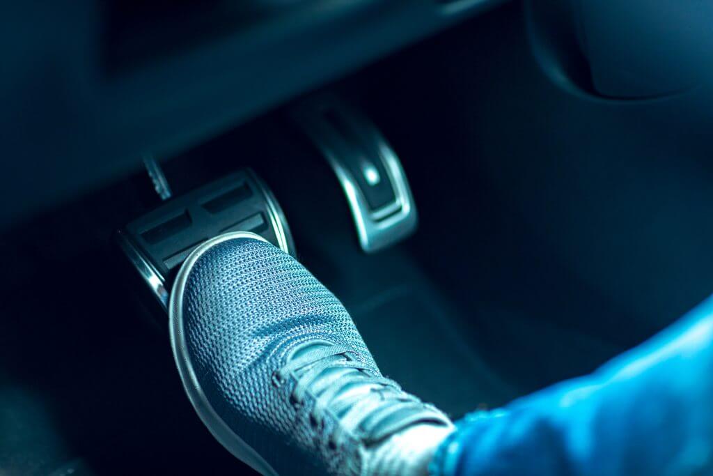 shoe stepping on a brake pedal