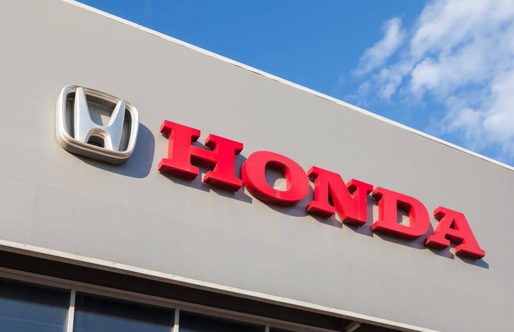 SAMARA, RUSSIA - AUGUST 30, 2014: Honda dealership sign against blue sky. Honda Motor Co., Ltd. is a Japanese public multinational corporation known as a manufacturer of automobiles, motorcycles and power equipment