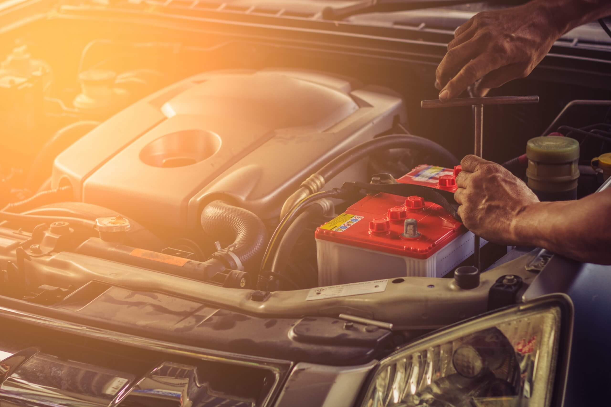 Car service ,fitting a car battery with wrench . soft focus photo