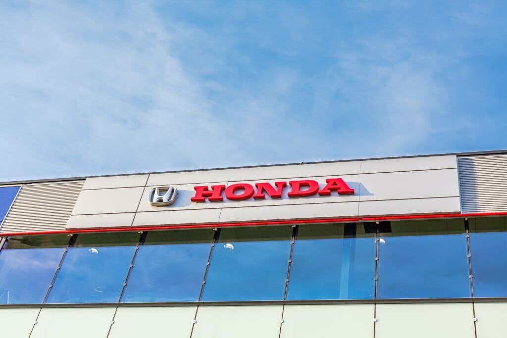 Honda brand logo on bright blue sky background located on its dealer office building in Lyon, France