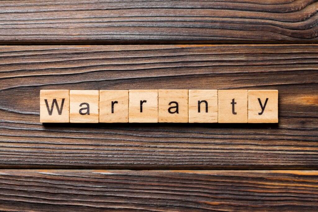 warranty word written on wood block. warranty text on table, concept.