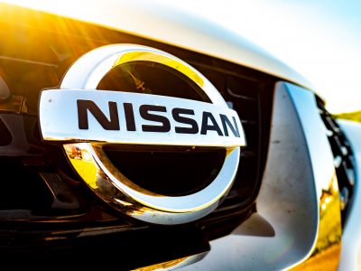 SURREY, UK- MAY, 2020: Nissan logo on front grill of white Nissan