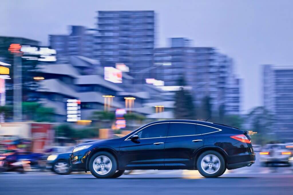 BEIJING-MAY 23. Honda Crosstour riding in city center at twilight. With 280,460 units Honda has set monthly records last month for automobile production overseas and in Asia. Beijing, May 23, 2013.