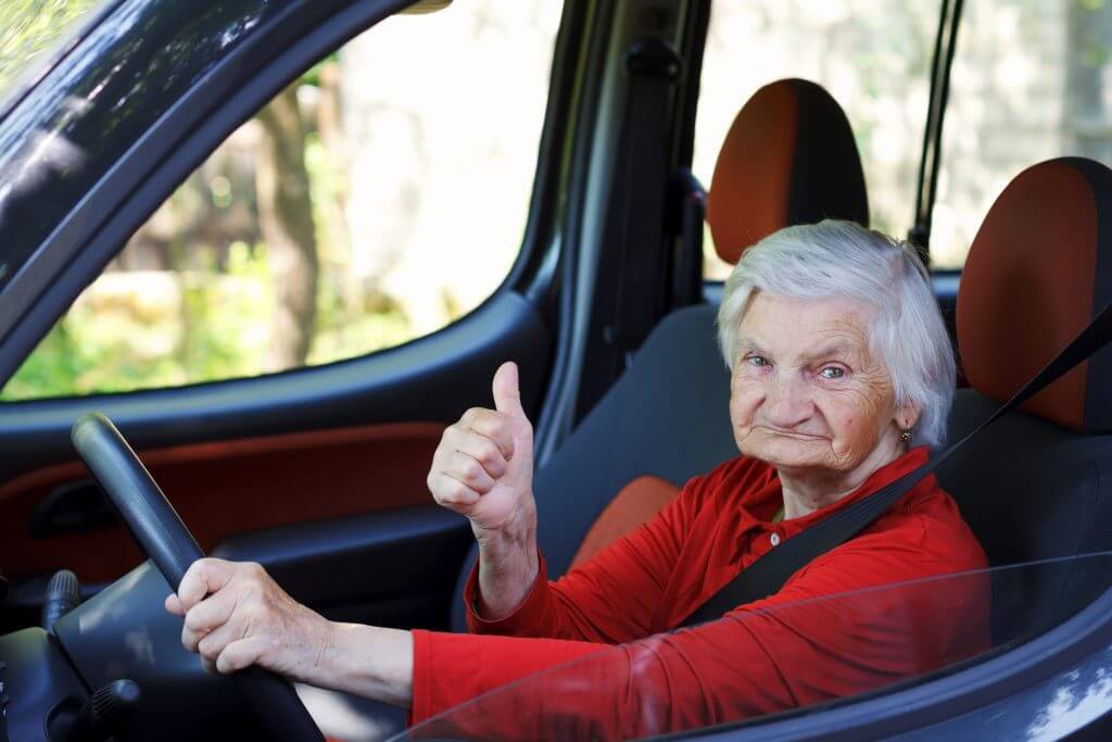 Picture of a confident senior woman driving a car
