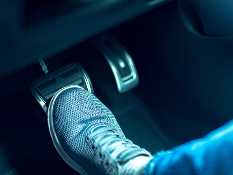 shoe stepping on a brake pedal