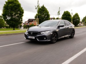 New Honda Civic in grey colour. New Honda design in urban environment.