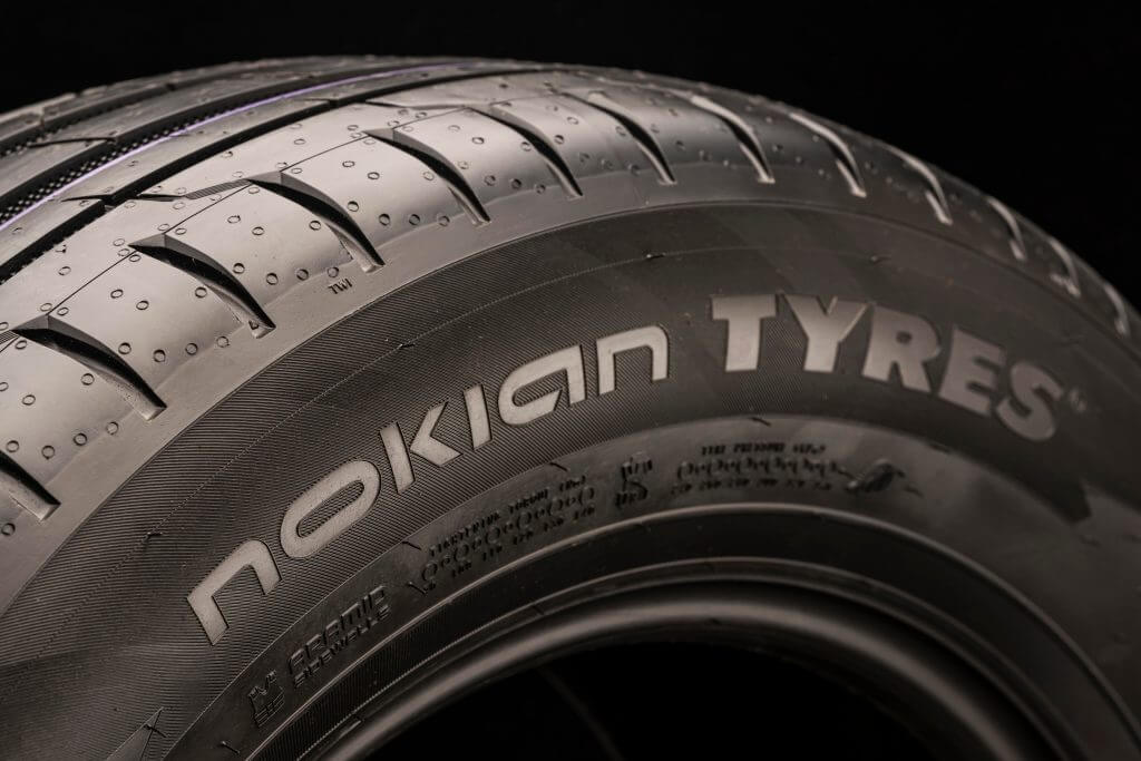 Nokian tyres , the logo of the Finnish tire company in close-up on the sidewall of the summer tire. dark background