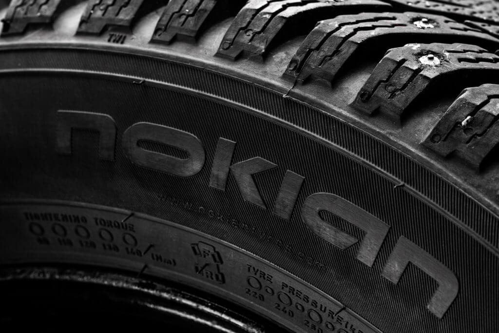 Kharkiv, Ukraine - 24 november 2020: Nokian hakkapeliitta winter studded tyres illustrative editorial. dark moody photo. close up view for a company logo.
