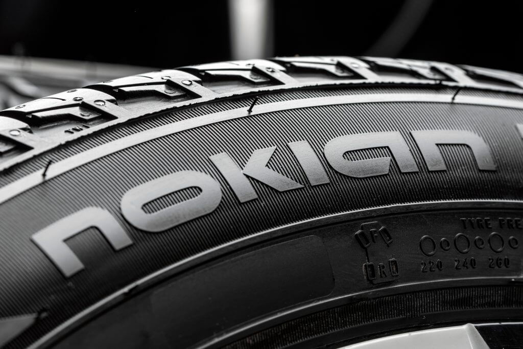 Nokian Tyres-the logo of the tire manufacturer on the sidewall of the tire in close-up. car wheel, white disc. Krasnoyarsk, Russia, March 29, 2021