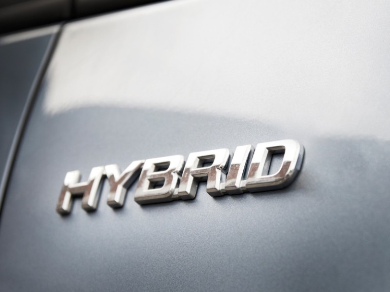 Hybrid inscription on the body of a modern car