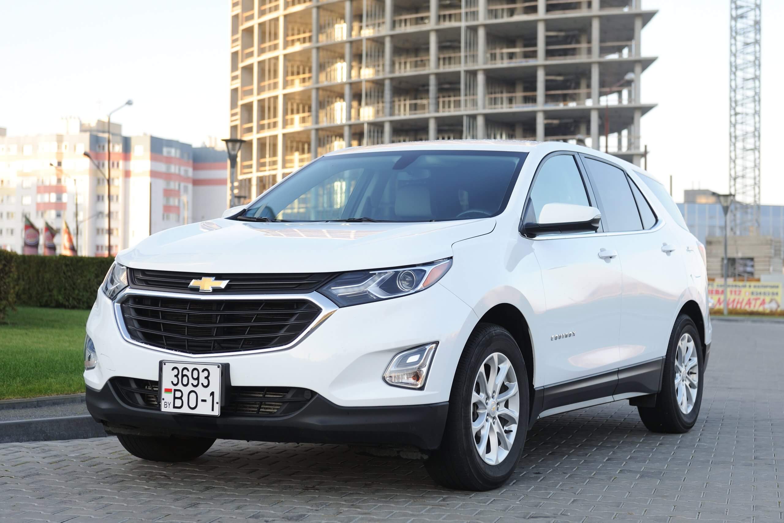 2017 Chevrolet Equinox SUV in white parked at city street