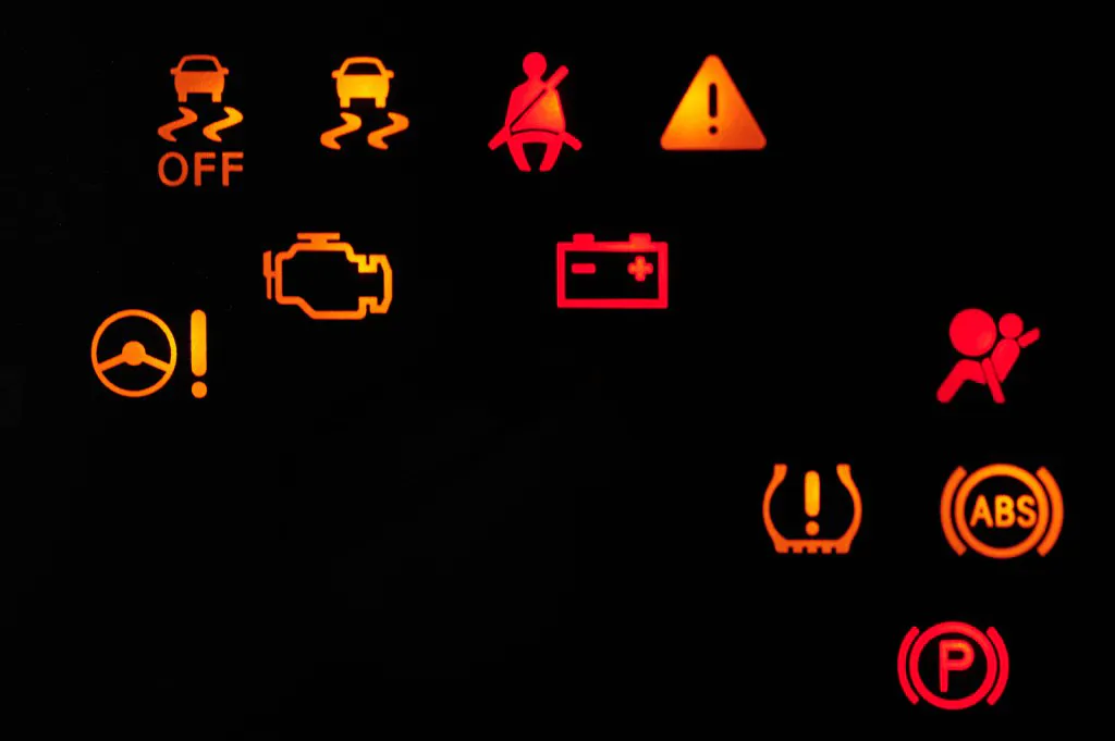 Car alert icons lamp on dashboard close up view