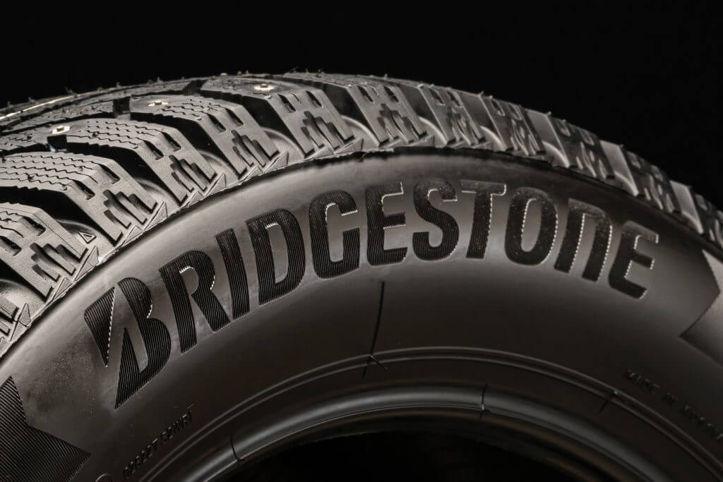 Krasnoyarsk, Russia, August 19, 2020: Bridgestone logo on the sidewall of the new tire, black background.