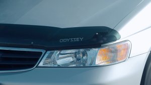 Honda Odyssey hood shield with the word "Odyssey" on it placed just above the headlight