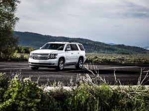 White Chevrolet Tahoe parked against a mountain
