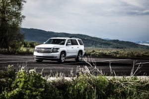 White Chevrolet Tahoe parked against a mountain