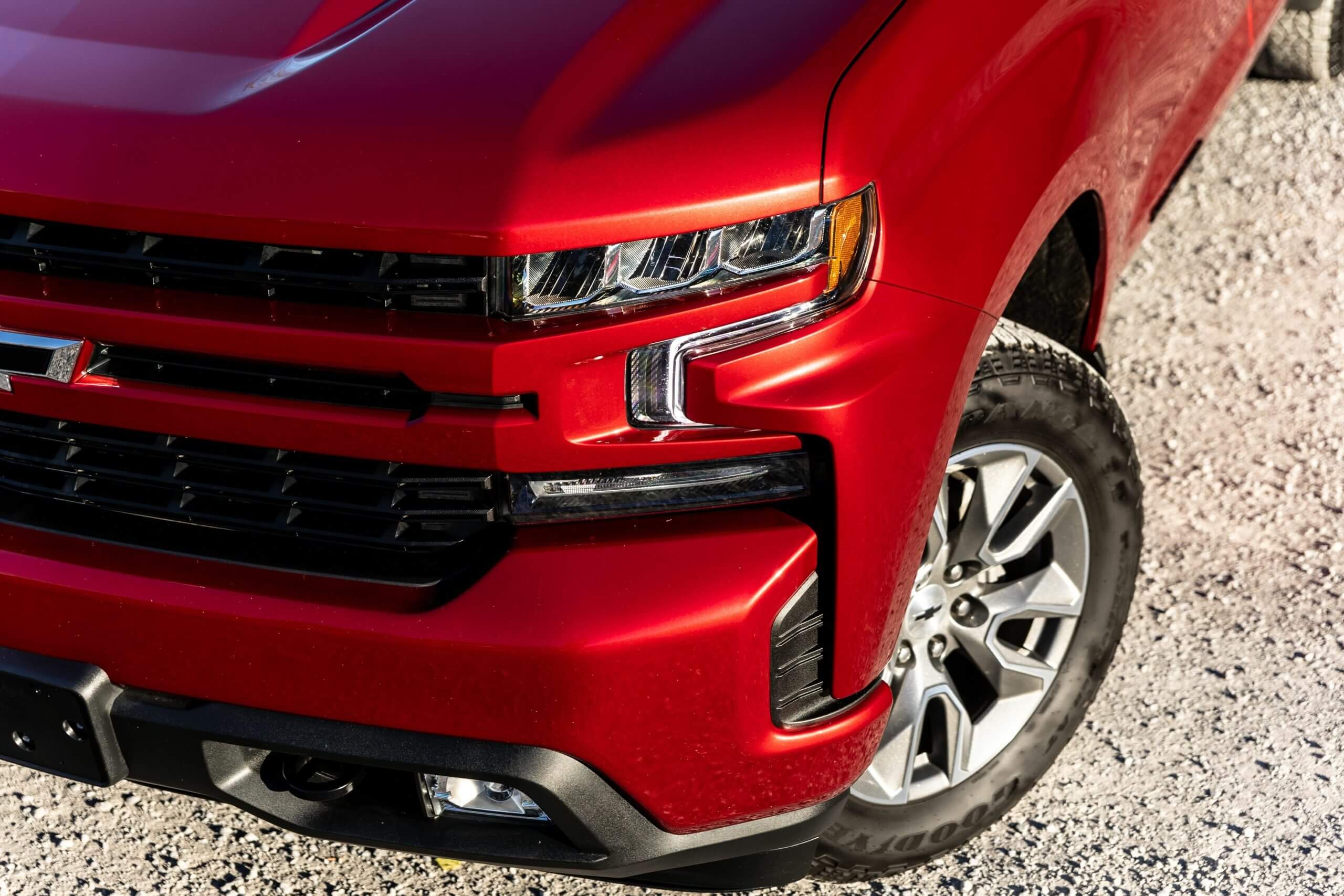Closeup of the front of a burgundy 2021 model Chevy Silverado 15
