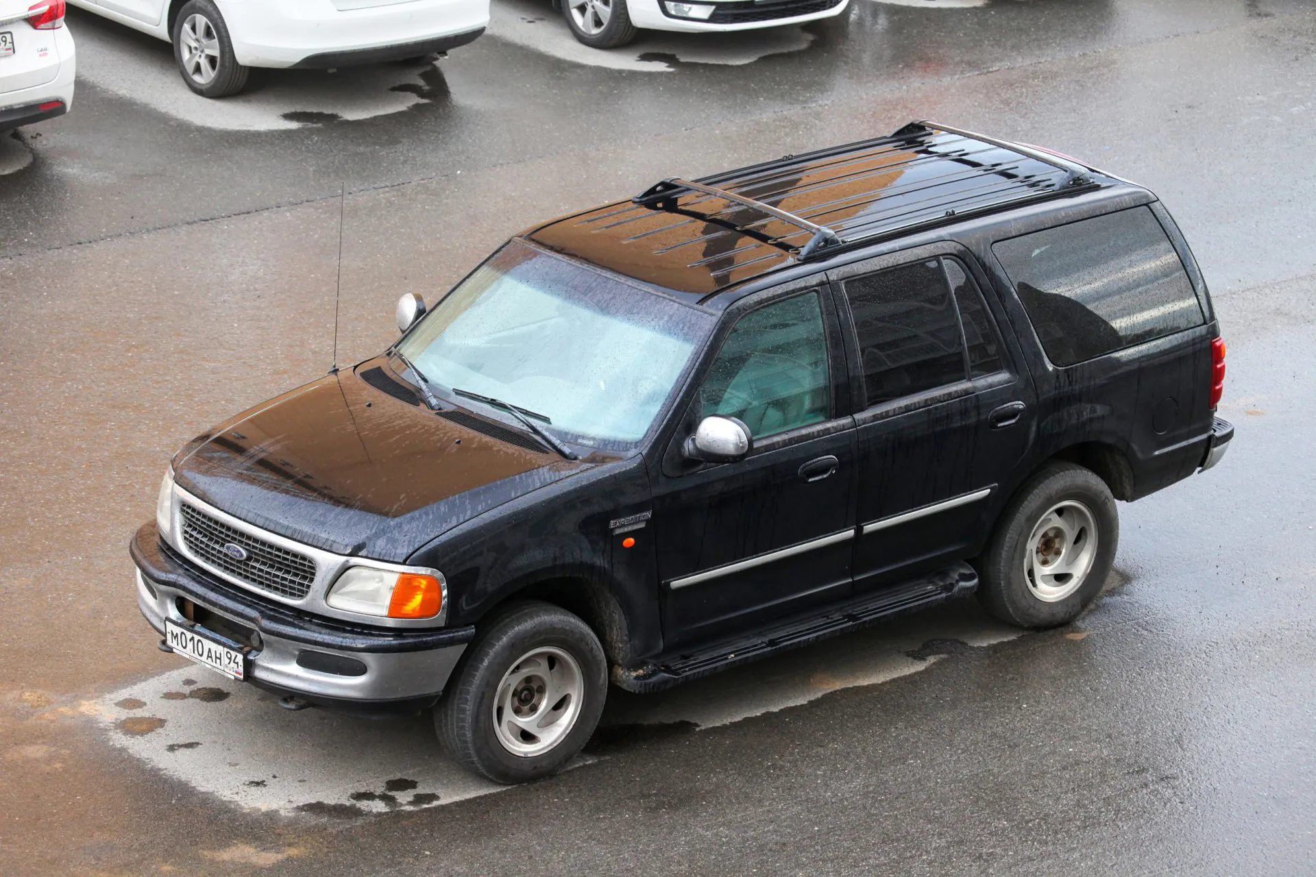 Black offroad car 2001 Ford Expedition in the city street.