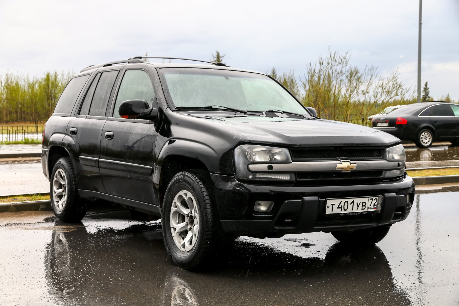 Black offroad car Chevrolet TrailBlazer in the city street.